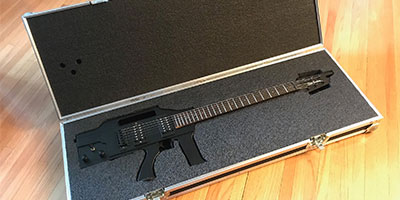 Gun shaped guitar in case